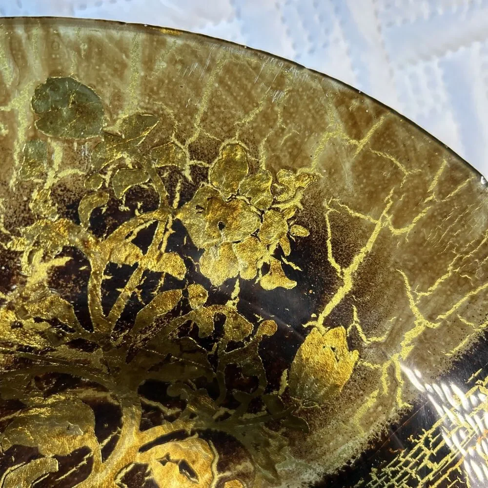 Glass bowl features an asymmetrical shape with a striking black and gold crackle